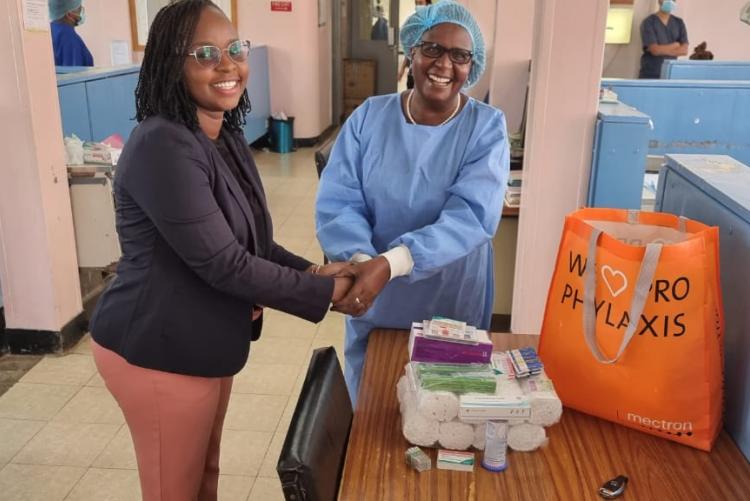 MDS student Dr. Kate Maundu presents her donation of Dental materials to the Department