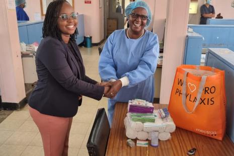 MDS student Dr. Kate Maundu presents her donation of Dental materials to the Department